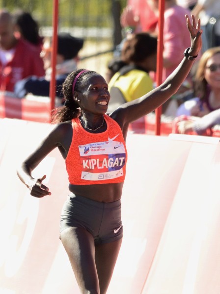 Florence Kiplagat, of Kenya, celebrates after winning the women's 2015 Bank of America Chicago Marathon, Sunday, Oct. 11, 2015, in Chicago. (AP Photo/Paul Beaty)