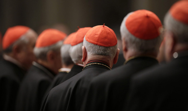 Cardinals attend a prayer at Saint Peter's Basilica in the Vatican March 6, 2013. Catholic cardinals said on Tuesday they wanted time to get to know each before choosing the next pope and meanwhile would seek more information on a secret report on alleged corruption in the Vatican. REUTERS/Max Rossi (ITALY - Tags: RELIGION)